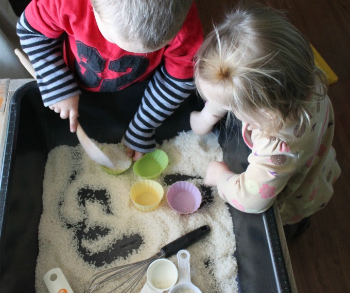 Pretend cooking with a rice sensory bin