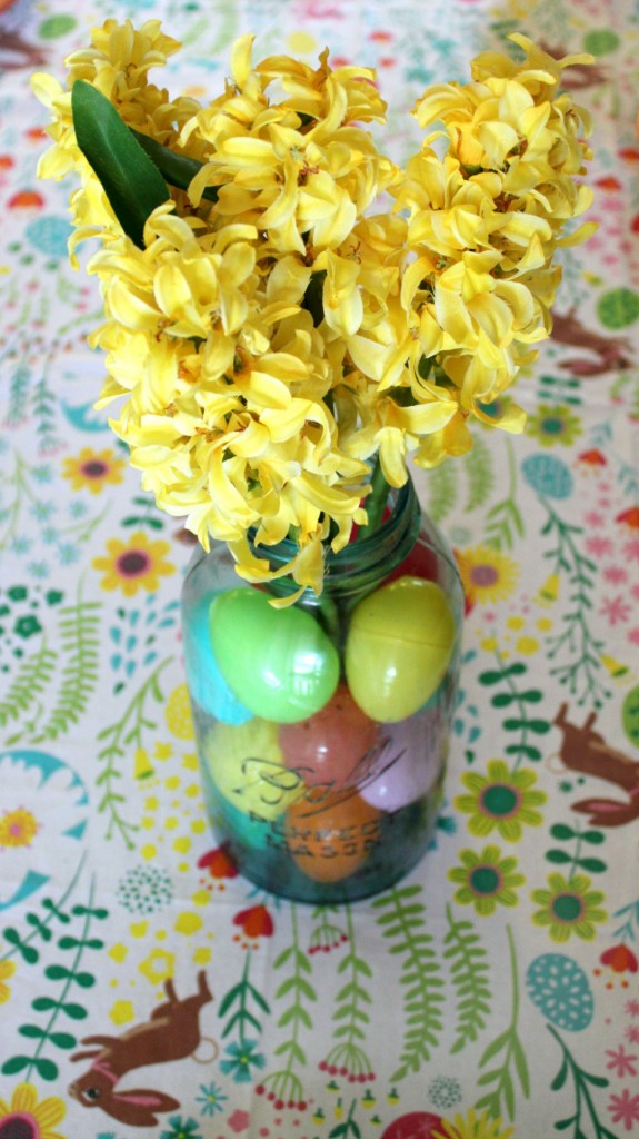 The Easiest Easter Centerpiece Ever - Fill a mason jar with plastic eggs and faux flowers